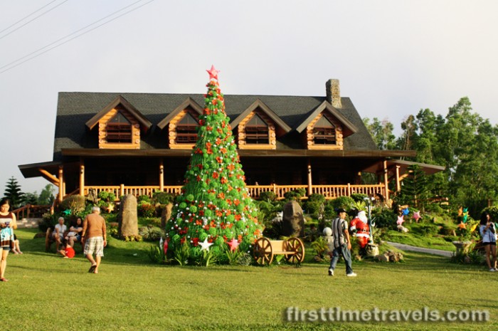 A Christmas tree adorns the front of the lodge.