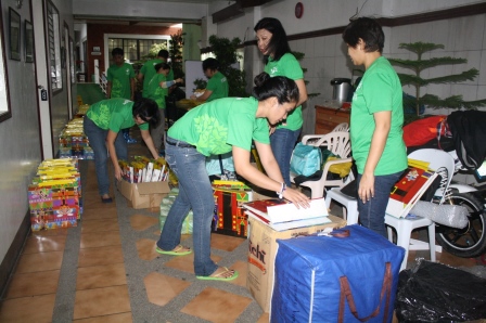 Volunteers getting busy unpacking the goods and re-packing our loot bags.