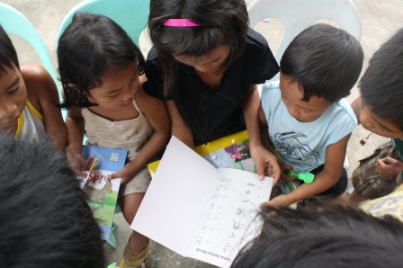 Children browse through the books they received.