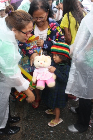 A kid received a stuffed toy donated by a child in Manila.