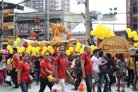 People wearing the lucky color red. The float at the background.