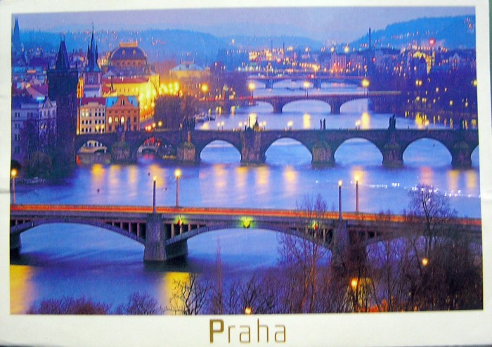The river, the bridges, the lights aglow give a surreal feel to Prague.