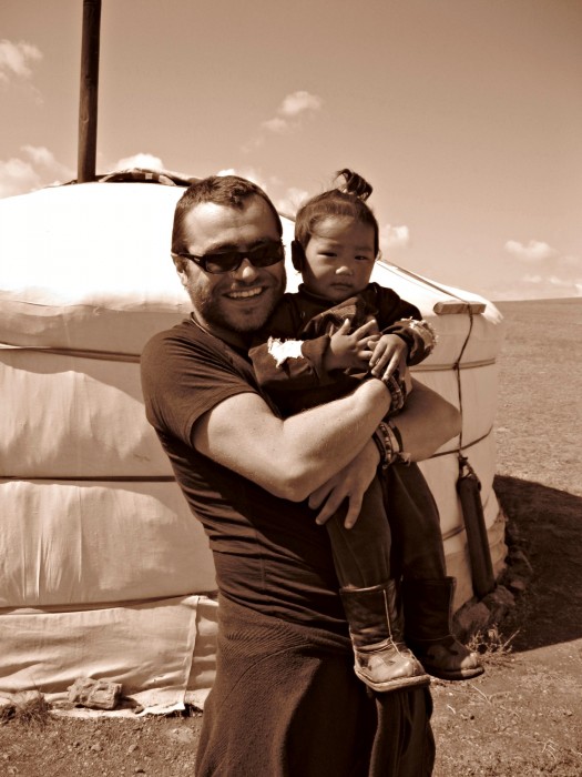 Paul poses with a child in Mongolia.
