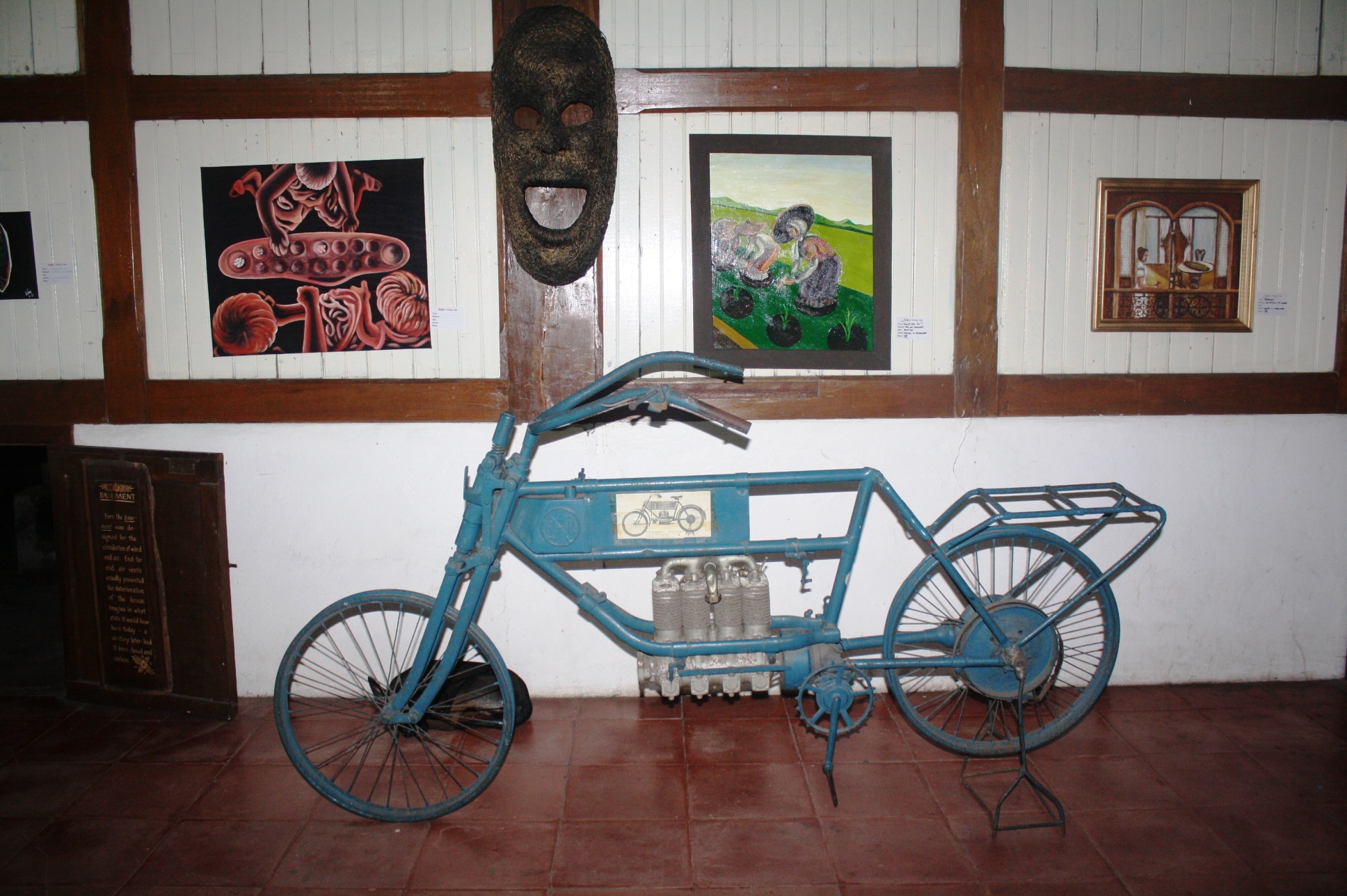The motorized bicycle parked at the back of the house.