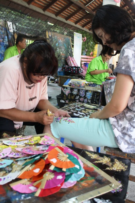 A visitor had her jeans painted by one of the artists.