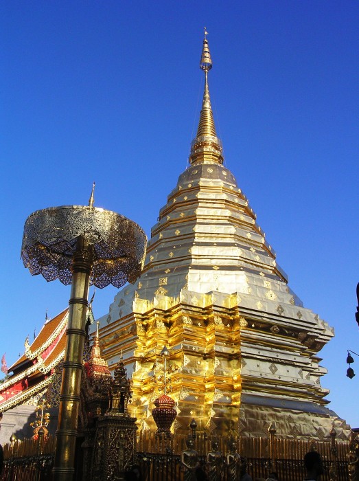 The golden stupa shines brightly under the sun.