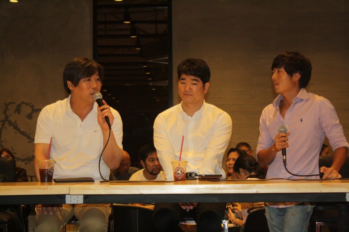Tom N Toms CEO Kim Do Kyun (left) answers questions from the media.