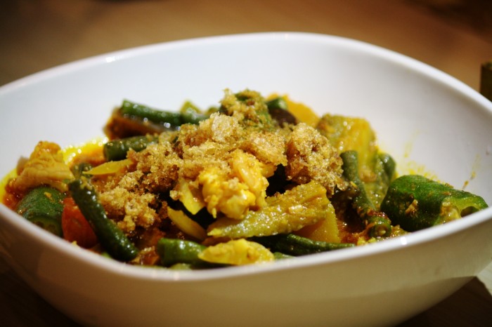Chicharon is sprinkled on top of the vegetables for the Pinakbet dish.